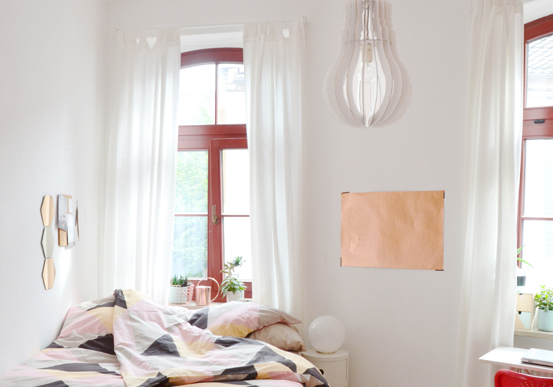 Skandinavisch eingerichtetes Schlafzimmer mit geometrischem Muster